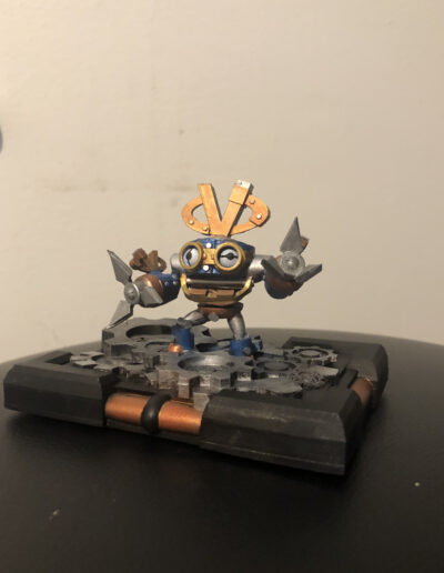 A custom Figure of VVind Up, an employee exclusive character of Vicarious Visions. Was painted as a variant using wind ups normal colors, and uses my now defunct base style meant to fit Writable NFC cards