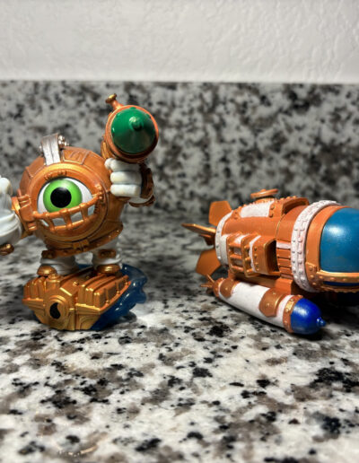 A repainted Dive Clops figure with their accompanying vehicle. Figure is painted as an instant variant.