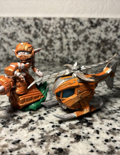 A repainted stealth elf figure with their accompanying vehicle. Figure is painted as an instant variant.