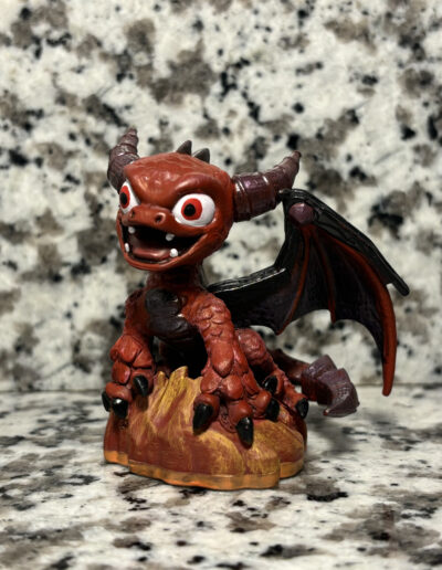 A repaint of series 2 Spyro from skylanders, converted into a red dragon found in concept art.